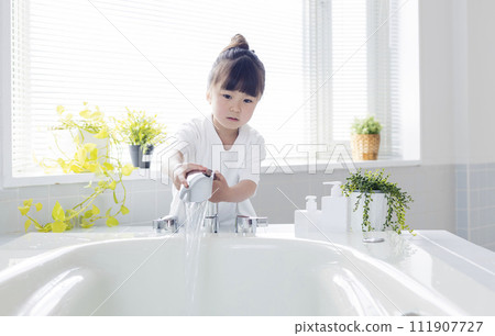 girl pouring hot water into the bath 111907727