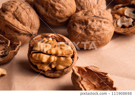 a handful of walnuts on kraft paper 111908698