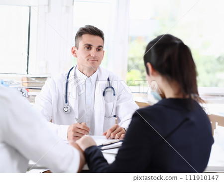 Male family doctor listen carefully young 111910147