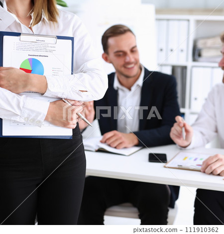Female arms hold silver pen and pad Female arms hold silver pen and pad 111910362