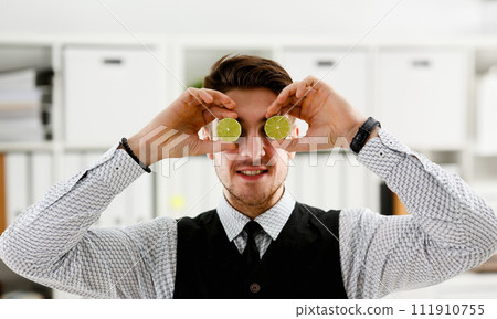 Male hands hold a cut fruit at eye level Male hands hold a cut fruit at eye level 111910755