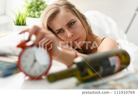 young woman wake up in the morning after night party young woman wake up in the morning after night party 111910769