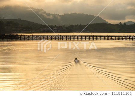 Motor boat sail to wooden Mon bridge at sunrise, Sangkhlaburi Motor boat sail to wooden Mon bridge at sunrise, Sangkhlaburi 111911105