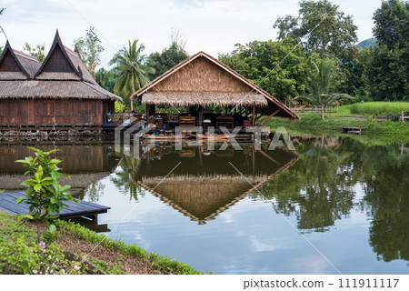 Traditional wooden thai house by canal with wood boat 111911117