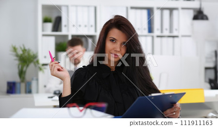 Beautiful smiling brunette woman hold in arms pink pen Beautiful smiling brunette woman hold in arms pink pen 111911163