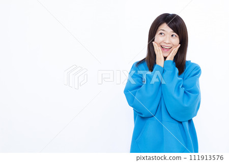 A woman wearing a surprising blue hoodie with a smile 111913576