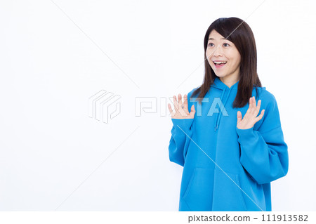 A woman wearing a surprising blue hoodie with a smile 111913582