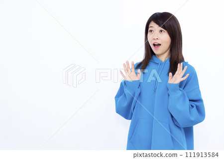 A woman wearing a surprising blue hoodie with a smile A woman wearing a surprising blue hoodie with a smile 111913584