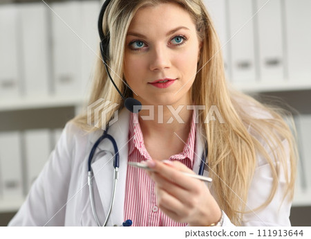 Portrait of happy smiling young doctor in headset 111913644