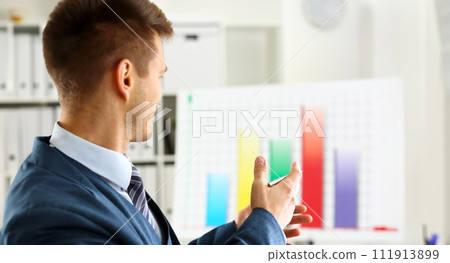 Man in suit point with arm in stats graph 111913899
