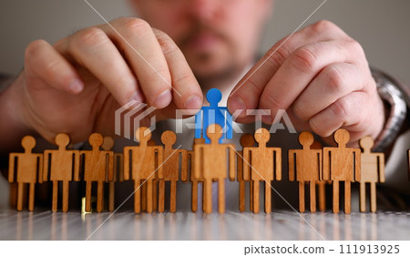Man arm in suit take little plastic toy figure Man arm in suit take little plastic toy figure 111913925