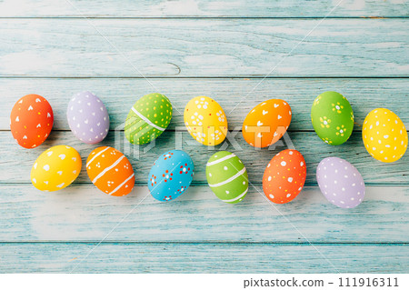 Easter Day Concept. Top view holiday banner background web design white colorful easter eggs painted on blue wood background with empty copy space, celebration greeting card, overhead, template 111916311