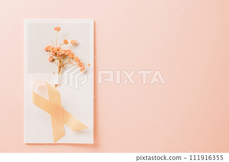 Pink awareness ribbon sign and paper card flower of World Cancer Day on pink background with copy space, concept of medical and health care support, Breast cancer awareness concept, 4 February 111916355