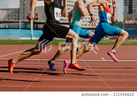 group male athletes sprinting on red track stadium, muscles taut, competing fiercely. summer sports games group male athletes sprinting on red track stadium, muscles taut, competing fiercely. summer sports games 111916828