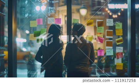AI-generated content. Two people brainstorming on a project with sticky notes at night 111917258
