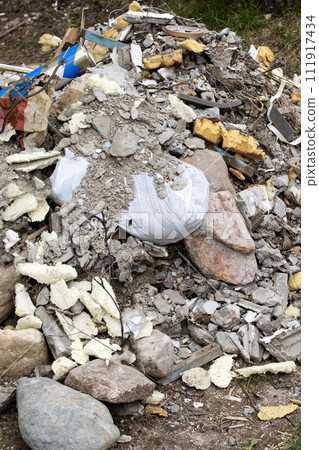 Pile of construction waste on the grass Pile of construction waste on the grass 111917434