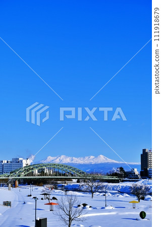 Asahikawa City, Hokkaido A view of Asahibashi Bridge and the Daisetsuzan Mountain Range Asahikawa City, Hokkaido A view of Asahibashi Bridge and the Daisetsuzan Mountain Range 111918679