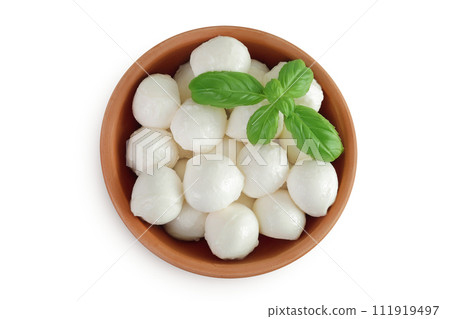 Mini mozzarella balls with basil in a ceramic bowl isolated on white background. Top view. Flat lay. 111919497