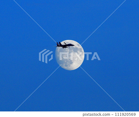 airplane flying over the moon 111920569