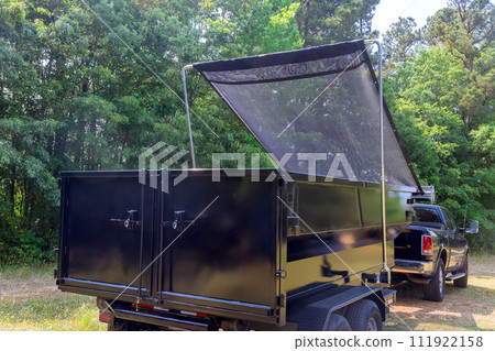 On construction site, there is dumpster made of metal for junk waste 111922158