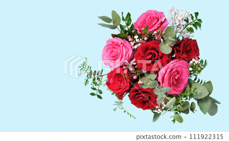 Horizontal banner with flatlay bouquet of pink and red roses on light blue background. Place for Your Text Horizontal banner with flatlay bouquet of pink and red roses on light blue background. Place for Your Text 111922315