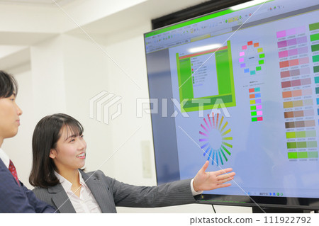 Designer woman explaining the color scheme for the website_1 Designer woman explaining the color scheme for the website_1 111922792