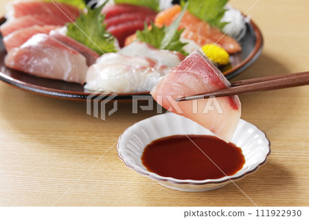 用筷子夾起看起來美味的生魚片 111922930