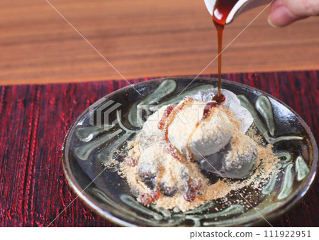 Warabi mochi topped with brown sugar syrup Warabi mochi topped with brown sugar syrup 111922951