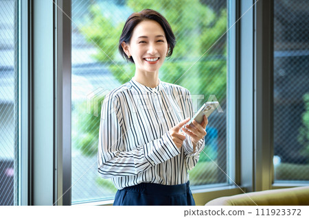 Middle business woman operating a smartphone 111923372