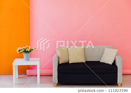 Black and grey office sofa in the interior of a multicolored room 111923596