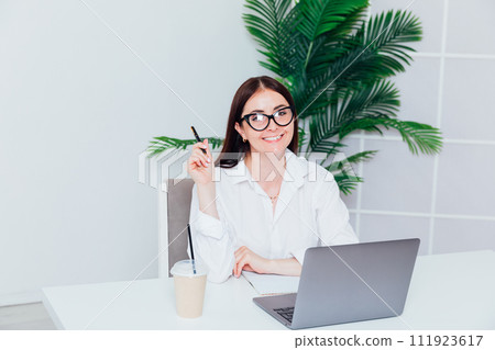 Business woman online on laptop from office 111923617