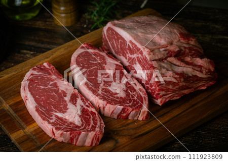 chunk of ribeye steak on wooden board chunk of ribeye steak on wooden board 111923809