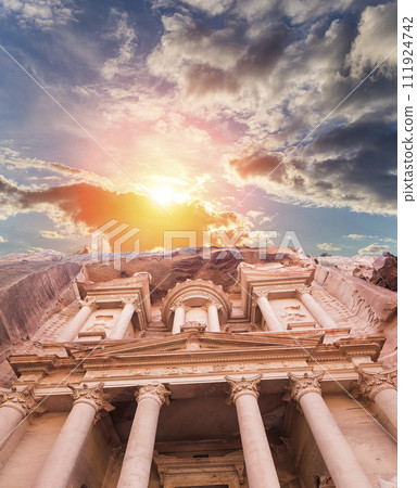 Al Khazneh or The Treasury (against the background of a beautiful sky with clouds). Petra, Jordan-- it is a symbol of Jordan, as well as Jordan's most-visited tourist attraction Al Khazneh or The Treasury (against the background of a beautiful sky with clouds). Petra, Jordan-- it is a symbol of Jordan, as well as Jordan's most-visited tourist attraction 111924742