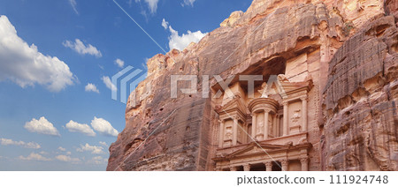 Al Khazneh or The Treasury (against the background of a beautiful sky with clouds). Petra, Jordan-- it is a symbol of Jordan, as well as Jordan's most-visited tourist attraction 111924748