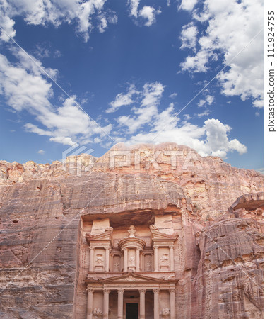 Al Khazneh or The Treasury (against the background of a beautiful sky with clouds). Petra, Jordan-- it is a symbol of Jordan, as well as Jordan's most-visited tourist attraction Al Khazneh or The Treasury (against the background of a beautiful sky with clouds). Petra, Jordan-- it is a symbol of Jordan, as well as Jordan's most-visited tourist attraction 111924755