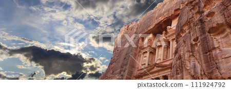 Al Khazneh or The Treasury (against the background of a beautiful sky with clouds). Petra, Jordan-- it is a symbol of Jordan, as well as Jordan's most-visited tourist attraction 111924792