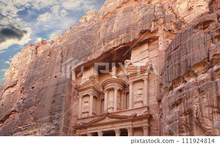 Al Khazneh or The Treasury (against the background of a beautiful sky with clouds). Petra, Jordan-- it is a symbol of Jordan, as well as Jordan's most-visited tourist attraction Al Khazneh or The Treasury (against the background of a beautiful sky with clouds). Petra, Jordan-- it is a symbol of Jordan, as well as Jordan's most-visited tourist attraction 111924814