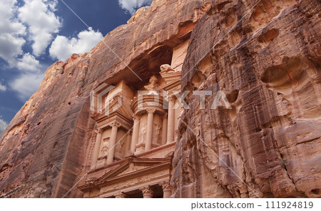 Al Khazneh or The Treasury (against the background of a beautiful sky with clouds). Petra, Jordan-- it is a symbol of Jordan, as well as Jordan's most-visited tourist attraction Al Khazneh or The Treasury (against the background of a beautiful sky with clouds). Petra, Jordan-- it is a symbol of Jordan, as well as Jordan's most-visited tourist attraction 111924819