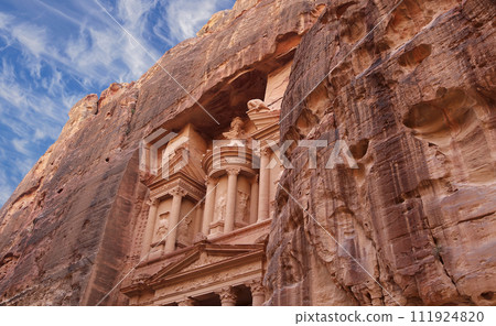 Al Khazneh or The Treasury (against the background of a beautiful sky with clouds). Petra, Jordan-- it is a symbol of Jordan, as well as Jordan's most-visited tourist attraction Al Khazneh or The Treasury (against the background of a beautiful sky with clouds). Petra, Jordan-- it is a symbol of Jordan, as well as Jordan's most-visited tourist attraction 111924820
