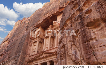 Al Khazneh or The Treasury (against the background of a beautiful sky with clouds). Petra, Jordan-- it is a symbol of Jordan, as well as Jordan's most-visited tourist attraction Al Khazneh or The Treasury (against the background of a beautiful sky with clouds). Petra, Jordan-- it is a symbol of Jordan, as well as Jordan's most-visited tourist attraction 111924821