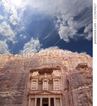 Al Khazneh or The Treasury (against the background of a beautiful sky with clouds). Petra, Jordan-- it is a symbol of Jordan, as well as Jordan's most-visited tourist attraction Al Khazneh or The Treasury (against the background of a beautiful sky with clouds). Petra, Jordan-- it is a symbol of Jordan, as well as Jordan's most-visited tourist attraction 111924827