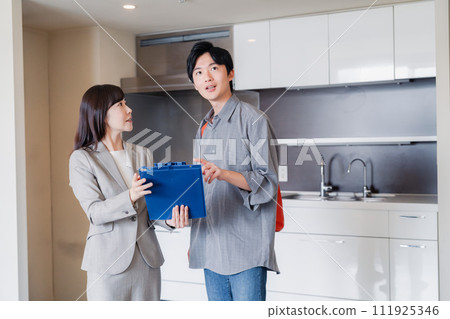 A young man inspecting a rental house A young man inspecting a rental house 111925346
