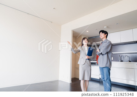 A young man inspecting a rental house 111925348