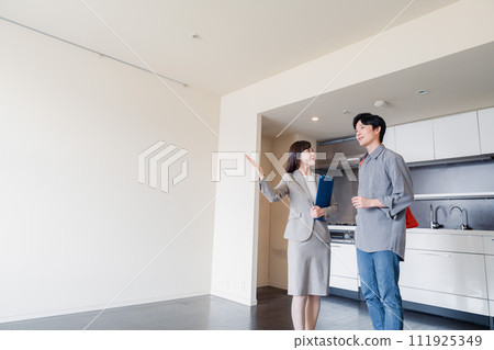 A young man inspecting a rental house 111925349