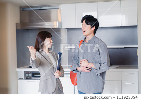 A young man inspecting a rental house 111925354