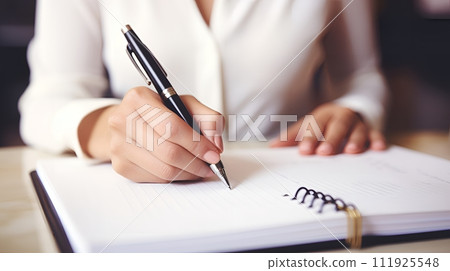 close up of woman hand with pen writing 111925548