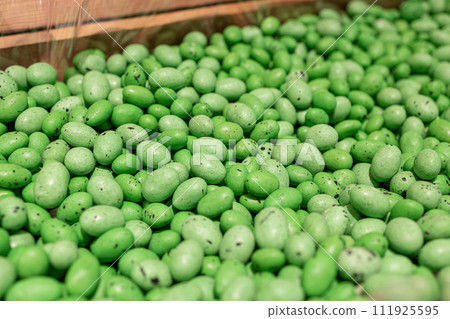 green jelly bean. chocolate dragee. dragee with nuts. sweet shop 111925595