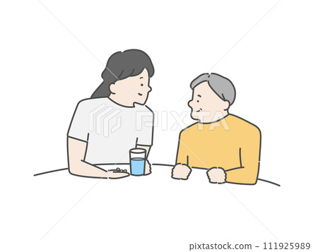 A female caregiver assisting an elderly man with taking medication. A female caregiver assisting an elderly man with taking medication. 111925989