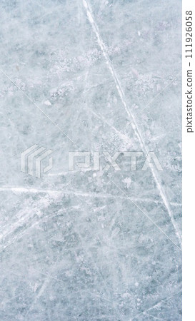 Ice background with marks from skating and hockey, blue texture of rink surface with scratches Ice background with marks from skating and hockey, blue texture of rink surface with scratches 111926058