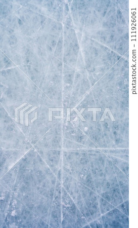 Ice background with marks from skating and hockey, blue texture of rink surface with scratches Ice background with marks from skating and hockey, blue texture of rink surface with scratches 111926061